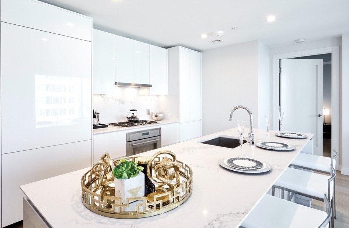 Pristine white kitchen with marble island